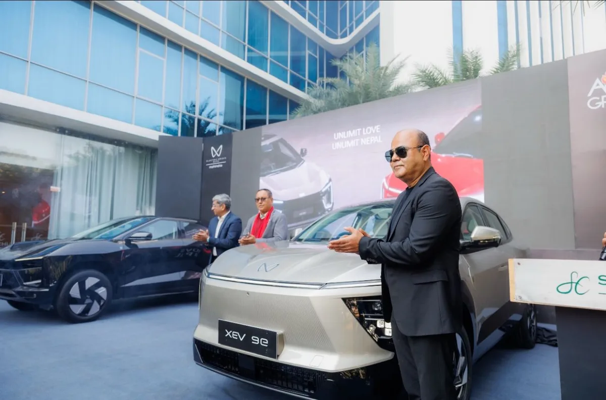 Cabinet Shrestha, right, beside an XEV 9e in front of an Agni Group backdrop
