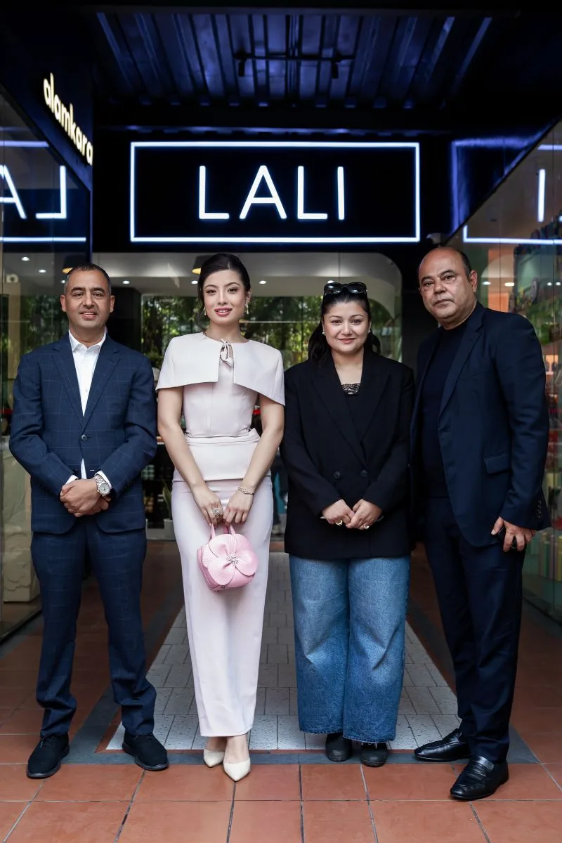Cabinet Shrestha, right, with three others under a LALI sign