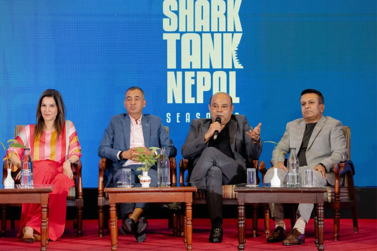 Cabinet Shrestha, third from left, speaking on a panel in front of a Shark Tank Nepal season two backdrop